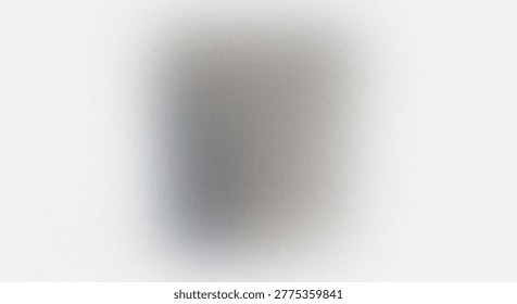 The image depicts a blurred background with subtle shades of gray. The central area is slightly darker, gradually blending into a lighter periphery. The overall effect creates a soft, diffused appearance with no discernible objects or features. The monochromatic color scheme adds to the minimalist aesthetic of the image.