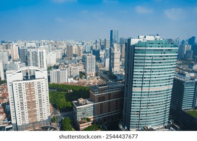 The image depicts Shanghai's urban landscape, featuring modern skyscrapers and a prominent cylindrical glass building, under a clear blue sky with greenery. - Powered by Shutterstock