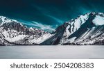 The image depicts a snowy mountain range in a natural landscape. The scene includes snow-covered peaks, a glacier, and a glacial lake. Tags: nature, mountain, landscape, snow, glacier, lake, winter.