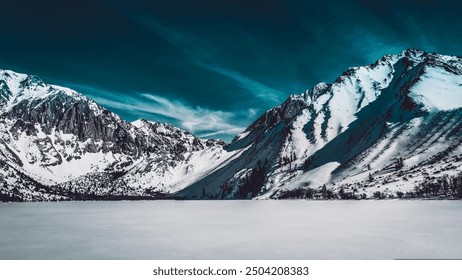 The image depicts a snowy mountain range in a natural landscape. The scene includes snow-covered peaks, a glacier, and a glacial lake. Tags: nature, mountain, landscape, snow, glacier, lake, winter. - Powered by Shutterstock