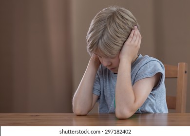 Image Of Depressed Young Boy Plugging Ears With Hands