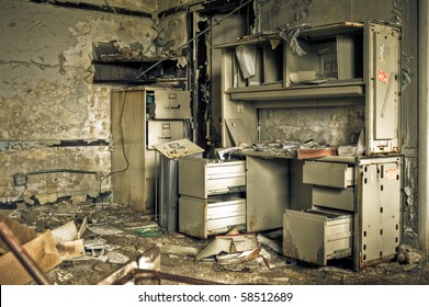 Image of a destroyed office in a derelict abandoned police station surrounded by crumbling walls with peeling paint. - Powered by Shutterstock