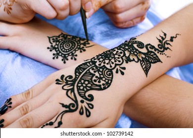 Image detail of henna being applied to hand