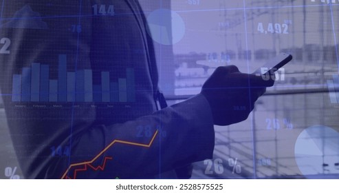 Image of diagrams and data processing over businessman using smartphone while walking. Global business, technology and digital interface concept digitally generated image. - Powered by Shutterstock - Get 15% off with code: PIKWIZARD15