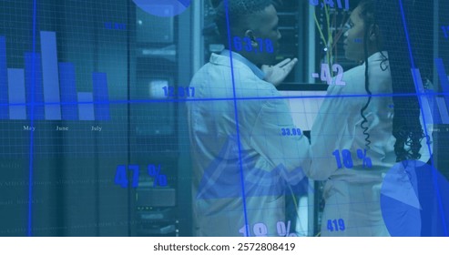Image of diagrams and data processing over biracial workers in server room. Technology and digital interface concept digitally generated image.