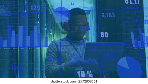 Image of diagrams and data processing over biracial male worker in server room. Technology and digital interface concept digitally generated image.