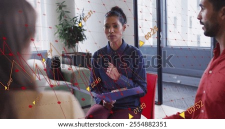 Image of diagrams and data processing over diverse colleagues discussing work in office. Technology, business and digital interface concept digitally generated image.