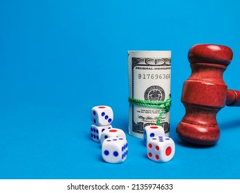 Image of dices,fake money and gavel against blue background. Law and regulation of gambling concept. - Shutterstock ID 2135974633