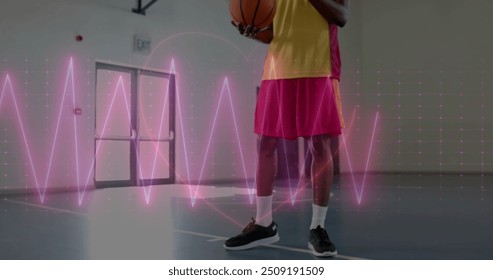 Image of digital data processing over african american basketball player on court. Global sports, competition, connections, computing and data processing concept digitally generated image. - Powered by Shutterstock