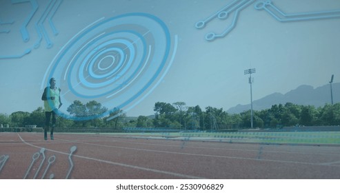 Image of digital data processing over disabled male athlete with running blades on racing track. global sports, competition, disability and digital interface concept digitally generated image. - Powered by Shutterstock