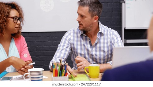 Image of digital icons with data processing over diverse business people in office. Global business, finances, computing and data processing concept digitally generated image.