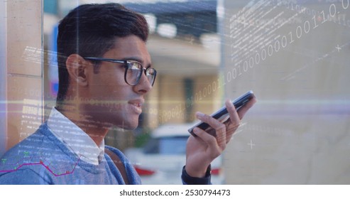 Image of digital interface with graphs, binary code, data and shifting light over smiling man talking on smartphone in street. Global digital communication network concept digital composite.