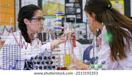 Image of digital interface with graphs and data moving over secondary school girls in a lab doing an experiment in a chemistry lesson. Global digital network and education digital composite.