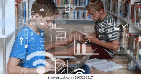 Image of digital interface with graphs and icons moving over two schoolboys sitting on floor in library studying using tablet and laptop. Global digital network and education digital composite.