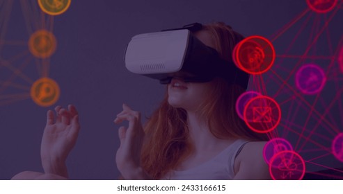Image of digital interface with icons and network of connections with woman wearing VR headset. Global computer network technology concept digitally generated image.