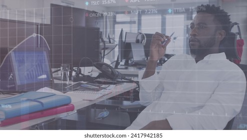 Image of digital interface showing statistics with man working in an office. Digital interface and global business, digitally generated image