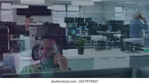 Image of digital interface showing statistics with diverse colleagues working together in an office. Digital interface and global business, digitally generated image
