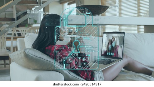 Image of digital padlock icon and data processing over woman using laptop on image call. Digital interface online security global connection and communication concept digitally generated image.