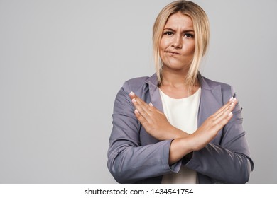 Image of displeased young pretty woman posing isolated over grey wall background make stop gesture. - Shutterstock ID 1434541754