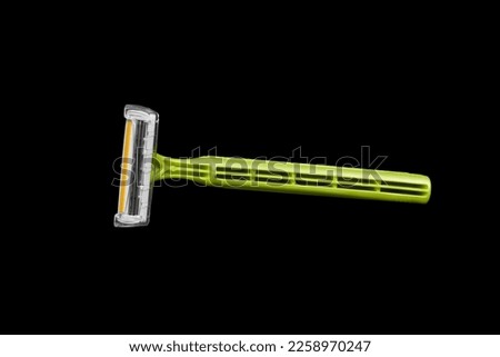 Image of a disposable shaving machine in green color on a black background