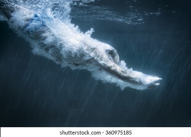 An Image Of A Diving Man In A Black Pool