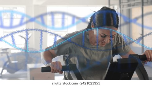 Image of dna strands over caucasian woman cross training on elliptical at gym. Fitness, exercise, strength, data, genetics and technology digitally generated image. - Powered by Shutterstock