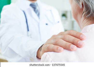 Image Of Doctor Hand On Patient Shoulder