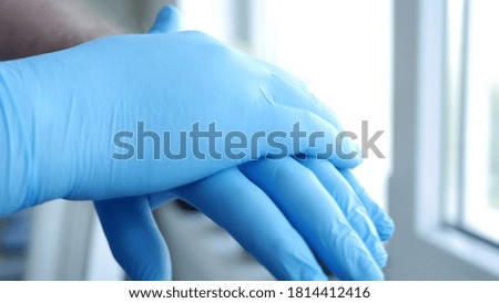 Image with Doctor Hands Wearing Surgical Gloves Needed in Protection Against Coronavirus Contamination