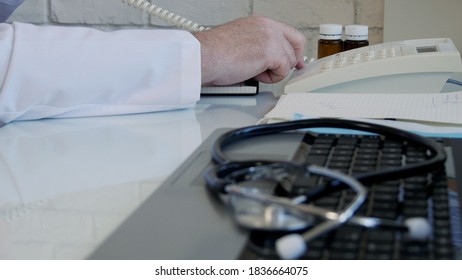 Image With A Doctor In Hospital Office Talking To The Landline