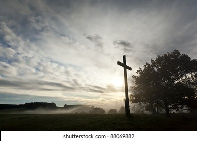 An image of a dramatic sky and a cross