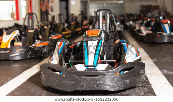 Image of driving cars for motor racing in sport\
club indoor, nobody