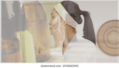 Image of dropper bottle of essential oil over happy biracial woman applying under eye mask. Nature, self care, beauty, relaxation, wellbeing and lifestyle, digitally generated image. - Powered by Shutterstock