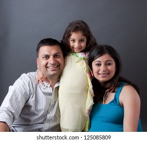 Image Of An East Indian Family With The Father, Mother And Their Daughter