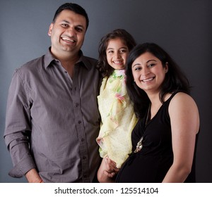 Image Of An East Indian Family With The Father, Mother And Their Daughter