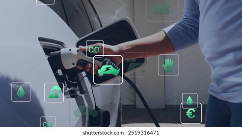 Image of eco icons and data processing over caucasian man charging electric car. Global green energy, connections, computing and data processing concept digitally generated image.