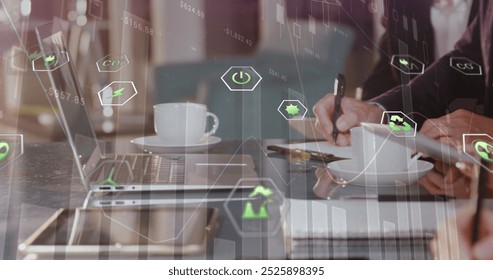 Image of eco icons and data processing over diverse business people in office. Global business, computing, digital interface and data processing concept digitally generated image.
