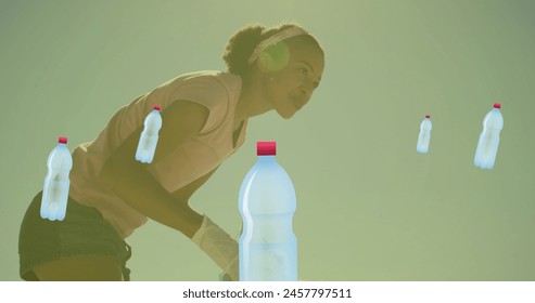 Image of ecology icons over african american female volunteer segregating waste. Recycle week, ecology and celebration concept digitally generated image. - Powered by Shutterstock