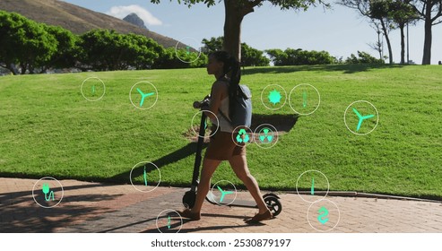 Image of ecology icons over biracial woman walking with scooter in park. health and fitness concept digitally generated image. - Powered by Shutterstock