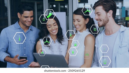 Image of ecology icons over diverse colleagues using laptop in office. Business, technology and digital interface concept digitally generated image. - Powered by Shutterstock