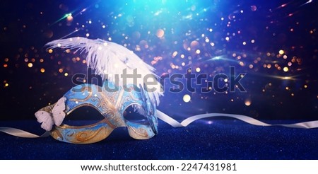 Image of elegant venetian mask over glitter background