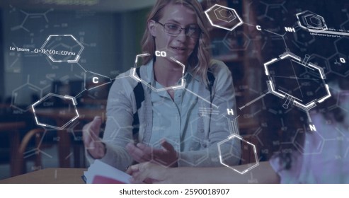 Image of elements and data processing over happy diverse female students talking in library. Chemistry, science, data, digital interface, education and learning, digitally