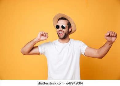 Image Of Emotional Man In Summer Hat Looking Aside Isolated Dancing.