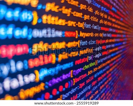 The image emphasizes technology, connectivity, and digital infrastructure. A closeup of colorful and glowing code lines on a screen, representing programming, speed, and complexity.
