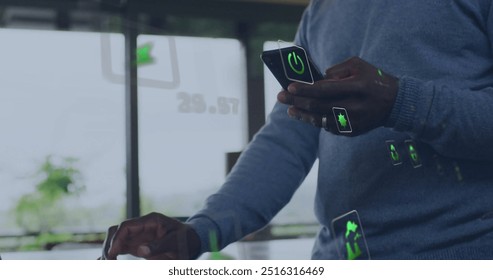 Image of energy and ecology icons over senior african american man using smartphone at home. Senior lifestyle, digital interface, energy, ecology and communication, digitally generated image. - Powered by Shutterstock