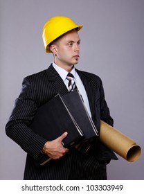 Image of engineer with folders posing in studio