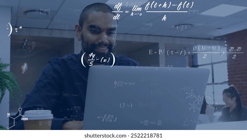 Image of equations at elements over happy biracial male student using laptop in classroom. Learning, education, data, science, mathematics and communication, digitally generated image.
