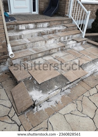 Image example showing a poorly done stone tile masonry job of a failing concrete staircase due to salt damage corrosion and improper installation.