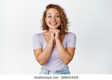 Image Of Excited Blond Girl Watching With Hopeful Face Expression, Smiling And Waiting, Anticipating Something Good, White Background