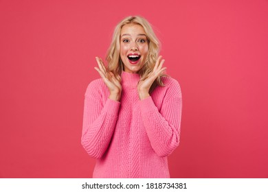 Image of excited blonde woman expressing surprise at camera isolated over pink background