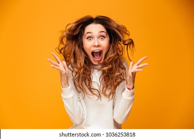 Image of excited screaming young woman standing isolated over yellow background. Looking camera. - Shutterstock ID 1036253818
